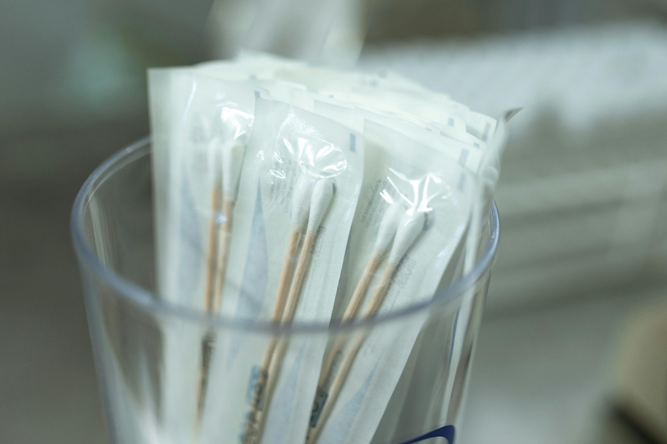 Wrapped cotton swabs in a glass jar.